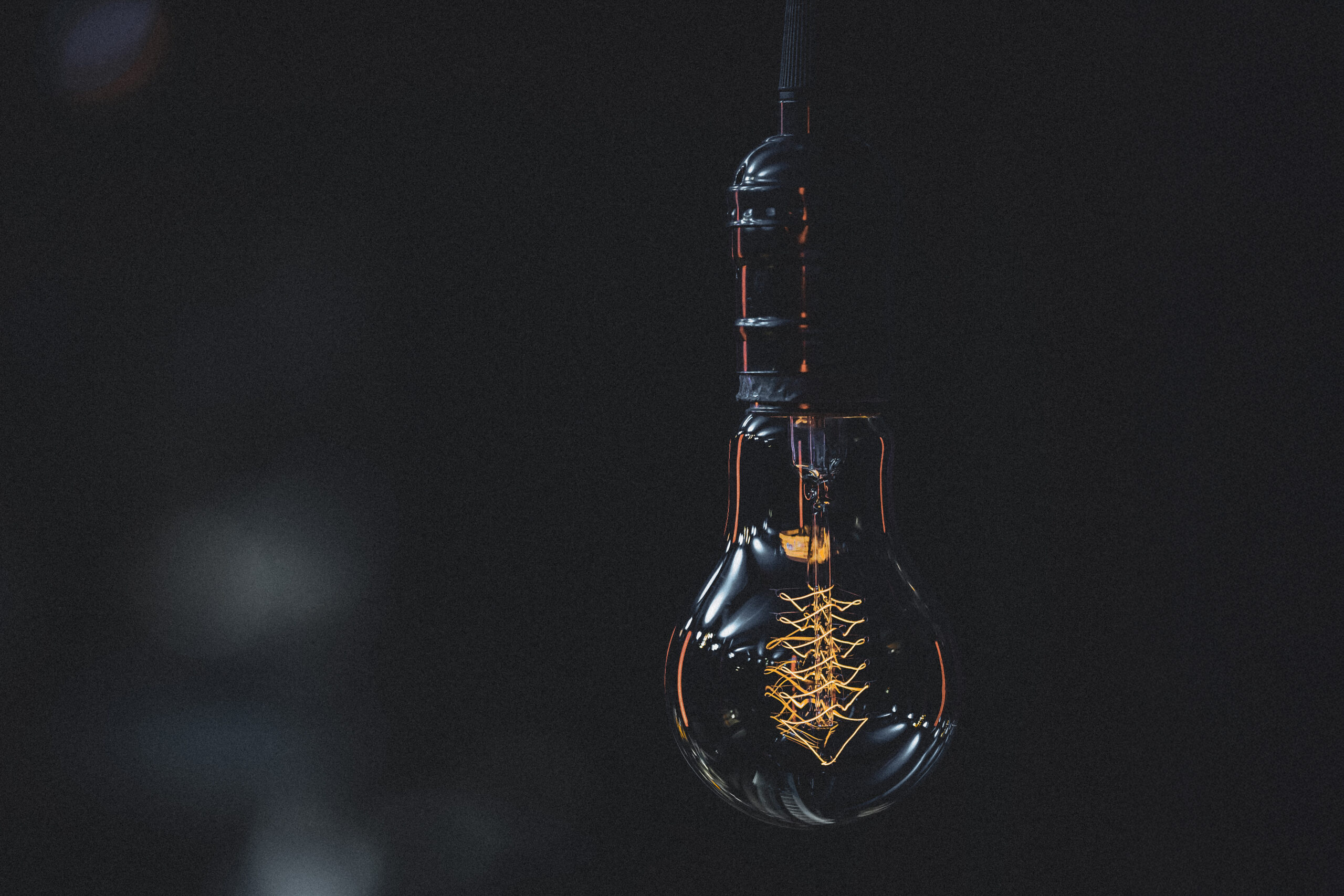 Silhouette of a non-glowing lamp in the dark copy space.